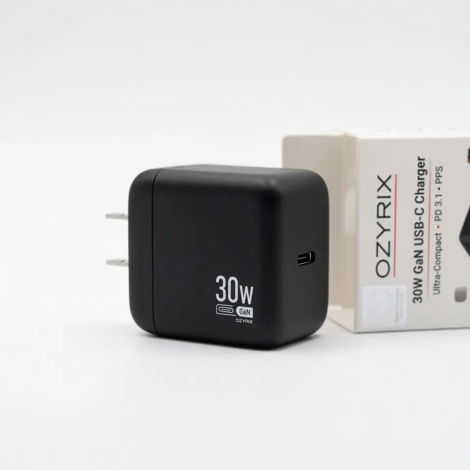 Catalogue photo of a black 30W USB-C charger next to its box